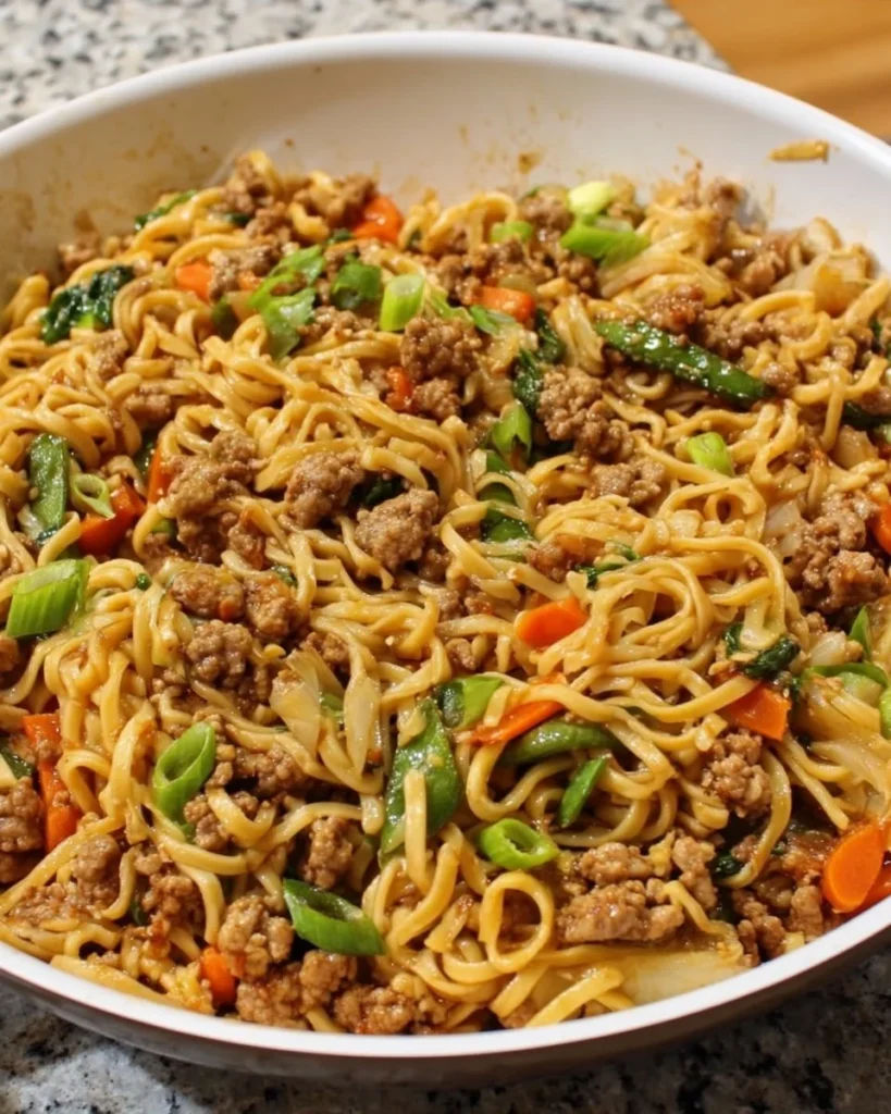 Delicious Pork Noodles Stir Fry with colorful vegetables in a bowl.