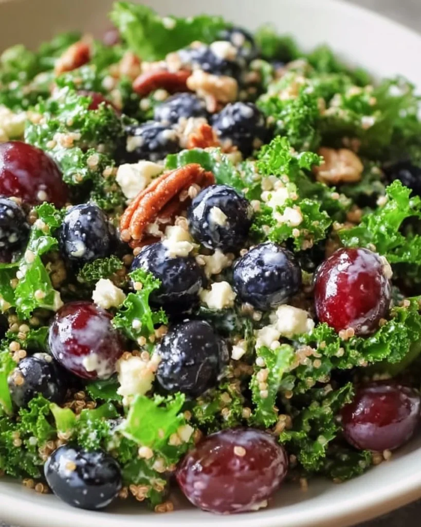 Colorful superfood salad with quinoa, kale, berries, and nuts for a healthy meal.