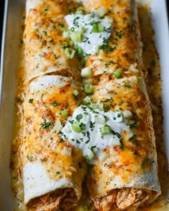Delicious smothered chicken burritos topped with savory sauce and fresh ingredients